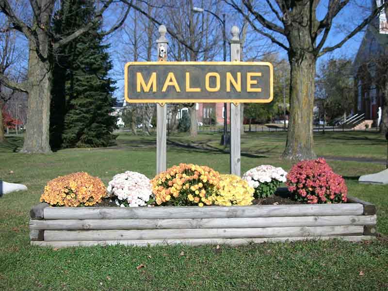 Town sign for Malone, NY