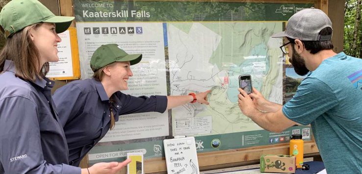 stewards at kaaterskill falls talk to a visitor