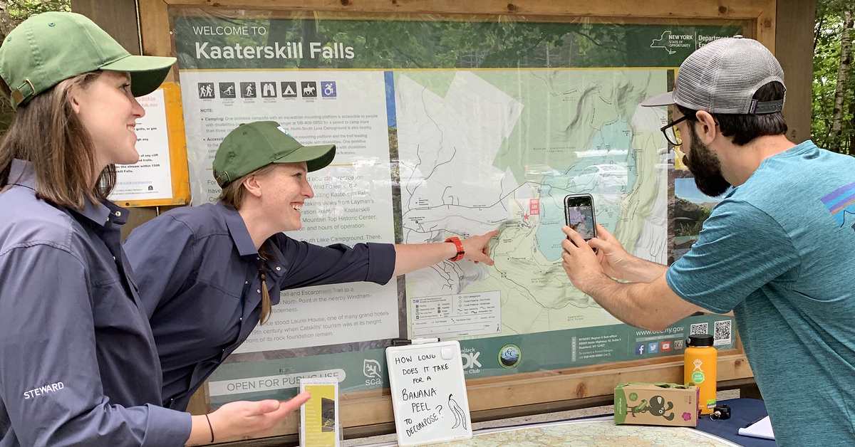 stewards at kaaterskill falls talk to a visitor