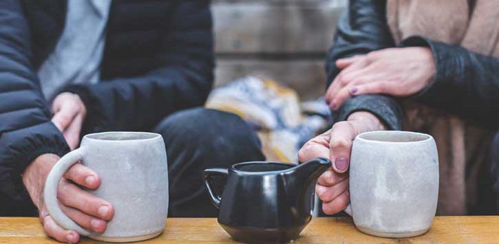 Two people enjoying cups of coffee