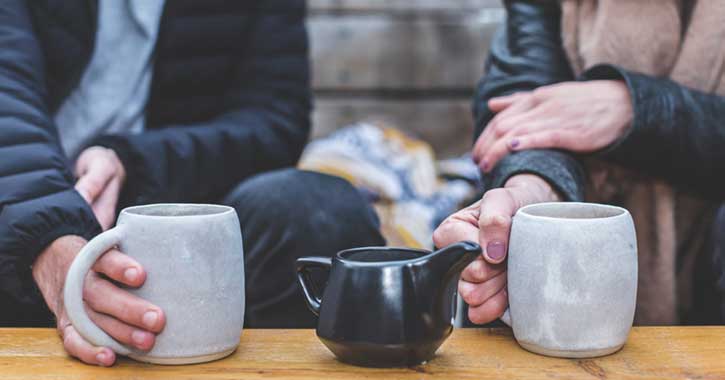 Two people enjoying cups of coffee