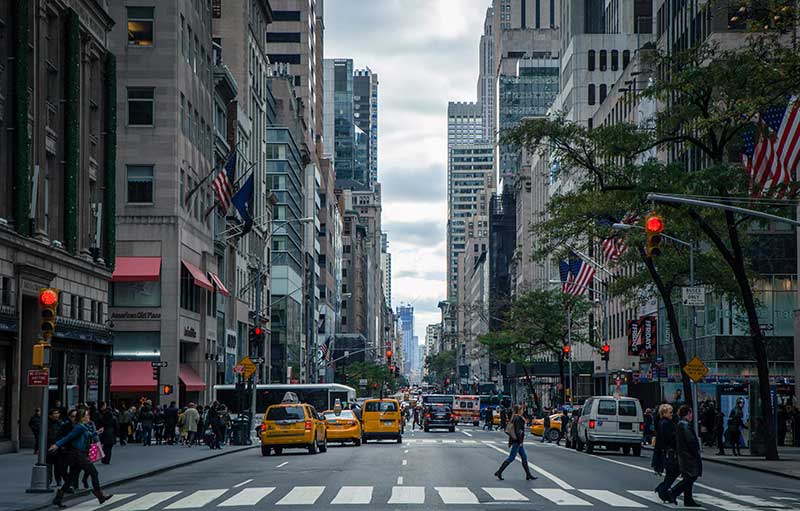 Street in New York City filled with taxis and pedestrians