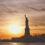 Statue of Liberty silhouetted against a sunrise