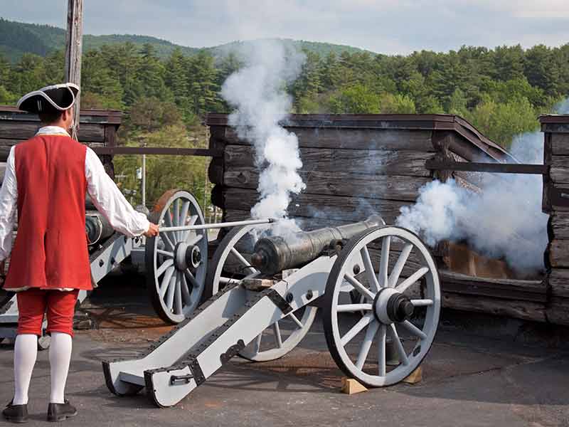 Reenactor firing a cannon at Fort William Henry
