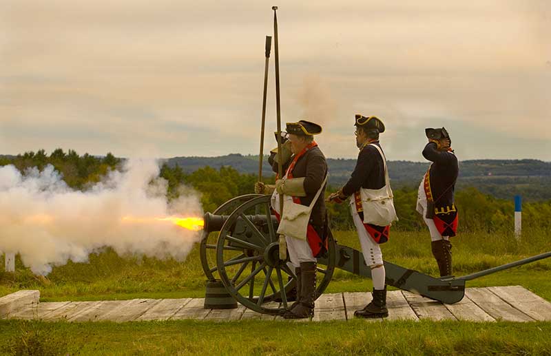 Revolutionary war reenactors firing a canon at Saratoga National Historic Park