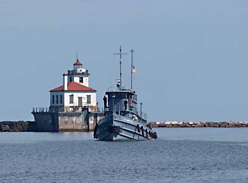 The Major Elisha K. Henson sails on Lake Ontario near Owsego Harbor West Pierhead Light